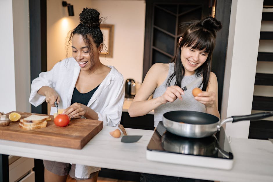 Two women cooking together at home, enjoying quality time with smiles and laughter.
