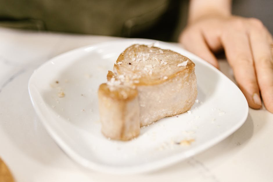 Close-up view of sliced bread piece on a white plate, ready to eat.