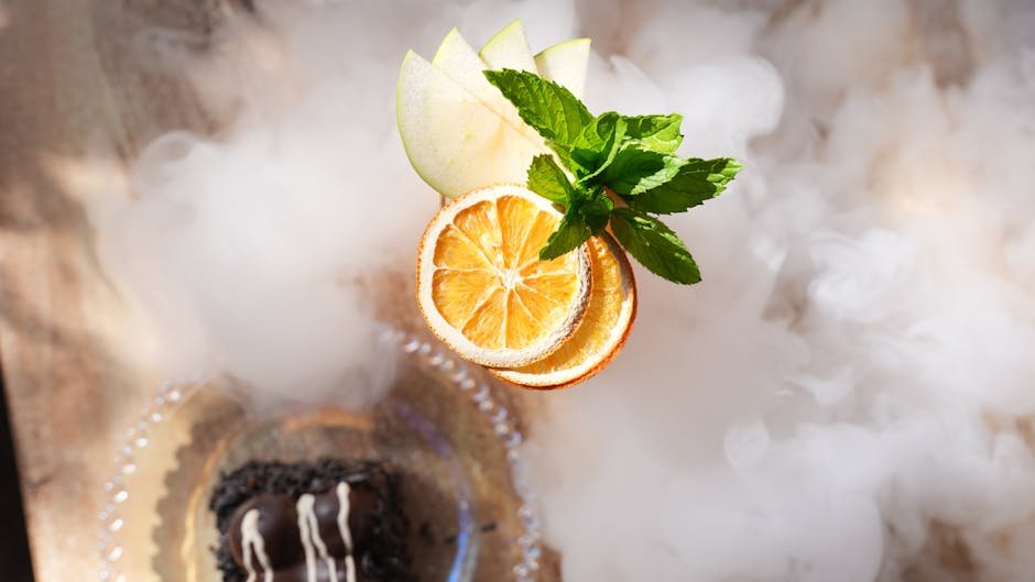 Sliced citrus and mint leaves beautifully arranged on a smoky background.