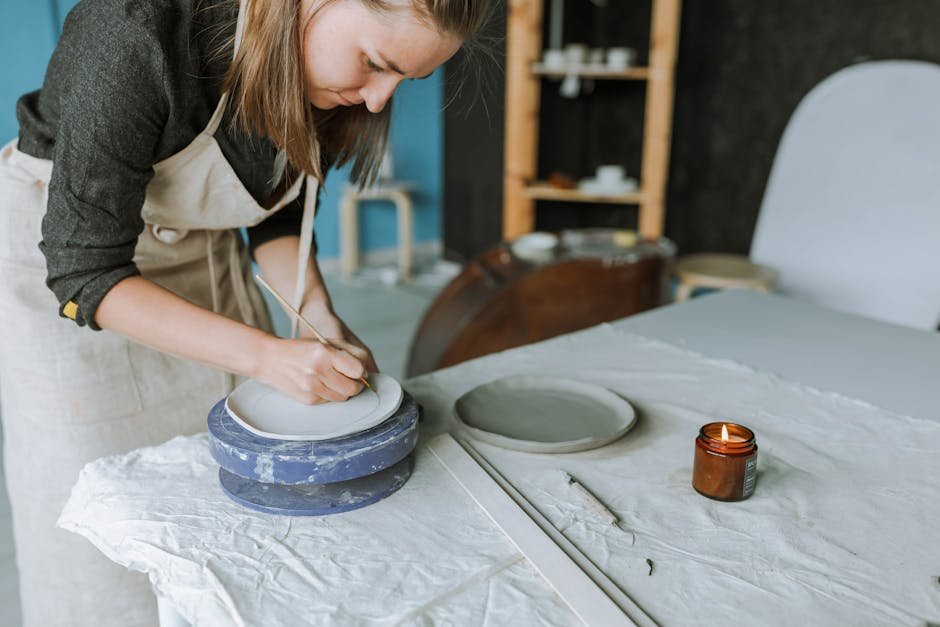A craftswoman intricately sculpts pottery in a serene studio setting, showcasing hands-on craftsmanship.